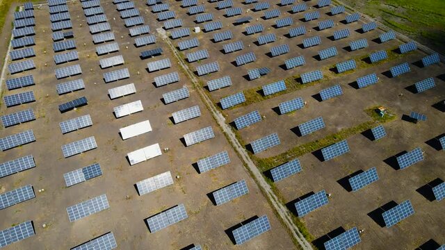 Aerial view to rows of modern photovoltaic solar panels.