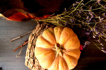 autumn leaves on a wooden background and pumpkin