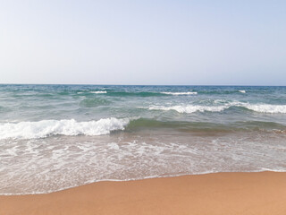 Fototapeta na wymiar Close-up soft wave of the sea on the sandy beach 
