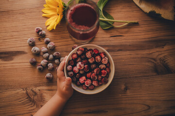 Still life. Frozen cherries and cherry juice on wooden background