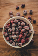 Still life. Frozen cherries on wooden background