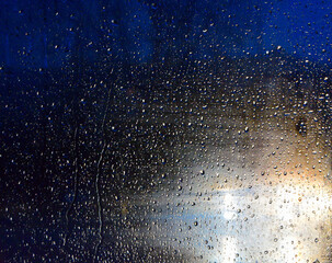 Rain drops on a car window at night