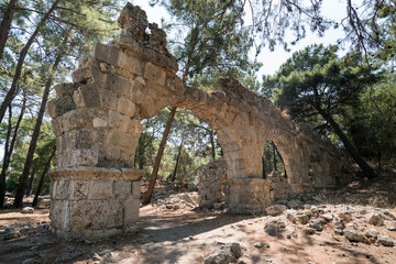 Fototapeta na wymiar The ruins of the ancient aqueduct at Phaselis in Tekirova Kemer. Founded by the Rhodians in the VII Century. Phaselis is also an ancient port city. Antalya province TURKEY 