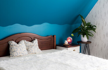 Tranquil blue color bedroom concept. Air cleaning plant Spathiphyllum on flower stand, Amethyst...
