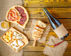 still life with cheese, bread, meat  and wine. horizontal image, copy space, negative space