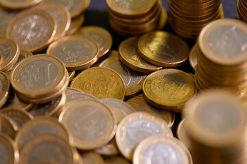 Stock Photo - Euro coins. Euro money. Euro currency.Coins stacked on each other in different positions. Money concept