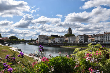 Fototapeta na wymiar the city of Saintes with flowers and the river in the foreground, photography for puzzle 