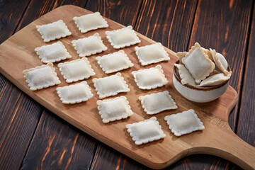 raw dumplings on teh wooden board