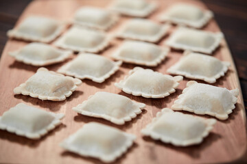raw dumplings on teh wooden board