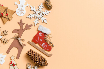 Top view of New Year toys and decorations on orange background. Christmas time concept with empty space for your design