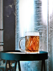 American Amber Ale. Cold beer in a mug. Industrial interior like a loft or a brewery.
