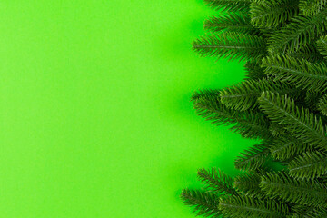 Top view of frame made of fir tree on colorful background with copy space. Merry Christmas concept