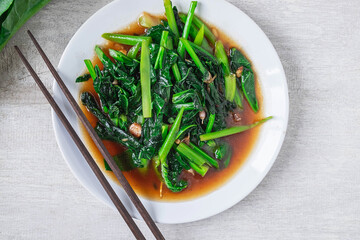 Fried Kale with Oyster Sauce menu on wooden table