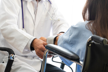 Rear View Of Woman Sitting At Doctor Office