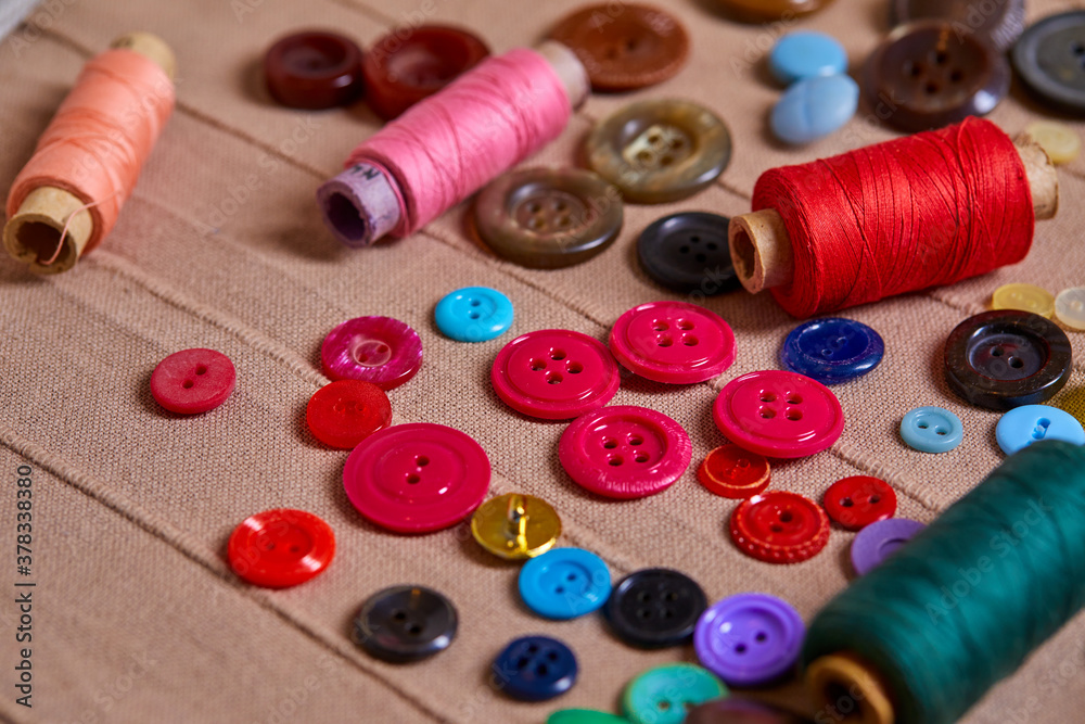 Poster Background and texture of multicolored antique buttons and sewing tools