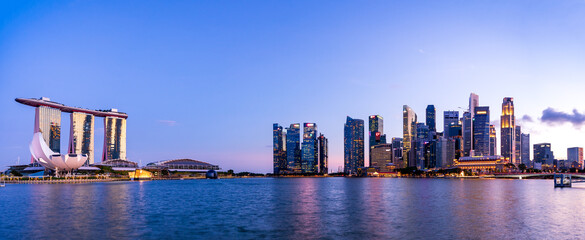 Wide panorama of Cityscape of Singapore Marina bay area at dusk.