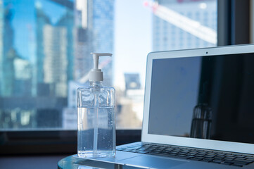 Hand sanitizer in front of laptop