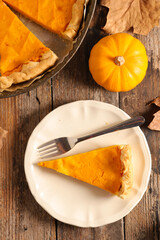 traditional pumpkin pie on wood background