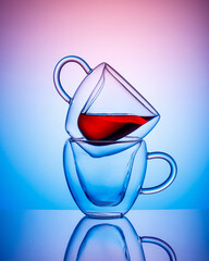 transparent cups on colored background. Vertical image. Copy space