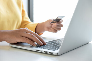 Fototapeta premium Woman using credit card register security code payments online shopping and customer service network connection market, using technology on laptop, Internet Online shopping or banking concept