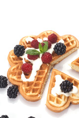 Belgium waffles with fresh berries isolated on white background