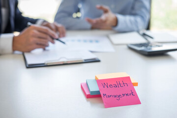 Wealth Management and financial concept, Team of Business accounting analyzing and calculation on valuation data investment fund and looking at report, sticky note paper and having a discussion