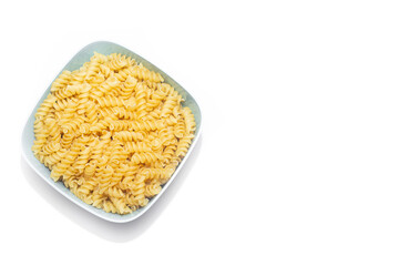 Fusilli macaroni placer . Macaroni on a plate. Article about pasta. Raw macaroni. Durum macaroni. . Copy space.