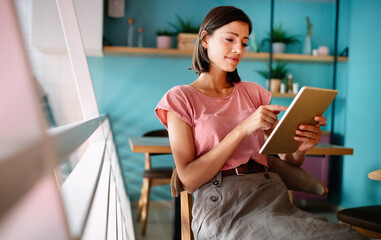 Portrait of cheerful woman using portable pc for blogging in social networks