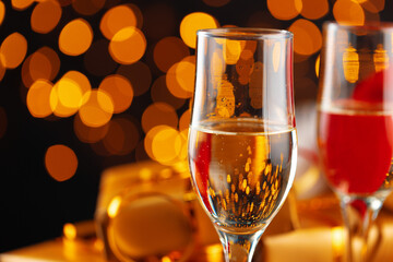 Champagne glass on blurred garland lights background