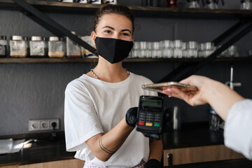 Woman barista wearing medical face mask