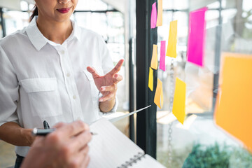 Business team working marketing growth on financial document graph report statistics, using post it notes in glass wall to writing strategy business plan to development grow to success