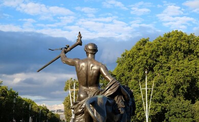 statue in london near buckingham palace trees blue sky clouds
