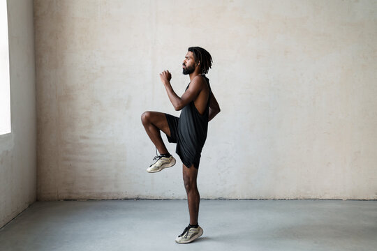 Image of african american sportsman doing exercise while working out