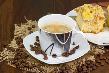 cup of coffee and apple cake on wooden background