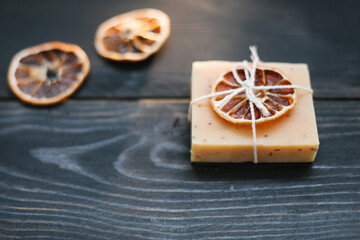 Natural citrus soap on dark background. Concept of Spa, Salon or Home body and skin care. Flat lay. Space for text, top view