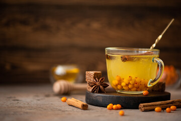 sea buckthorn tea with honey and spices in a glass mug