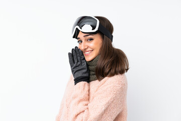 Skier girl with snowboarding glasses over isolated white wall whispering something