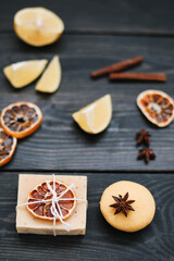 Natural citrus soap on dark background. Concept of Spa, Salon or Home body and skin care. Flat lay. Space for text, top view