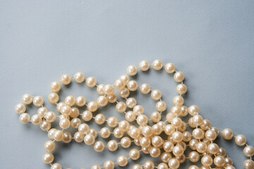 Pearl beads on a gray background decoration decoration top view