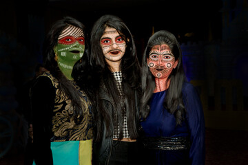 young women in witch halloween costumes