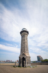 Tall stone lighthouse on Roosevelt Island in New York