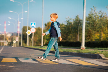 kid going to school, boy with backpack crossing the road