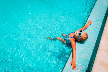 little girl relax in pool, kid enjoy vacation on beach resort