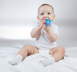 Photo of a ten-month-old baby with blue rattle