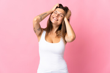 Obraz na płótnie Canvas Young slovak woman isolated on pink background laughing