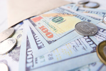 Close up of cash and coins in a envelope on table 