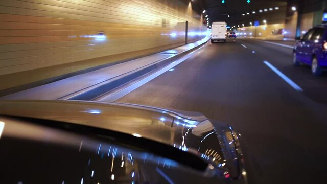Car movement along the tunnel highway lane in the city. Transportation of passengers by taxi in compliance with the rules.