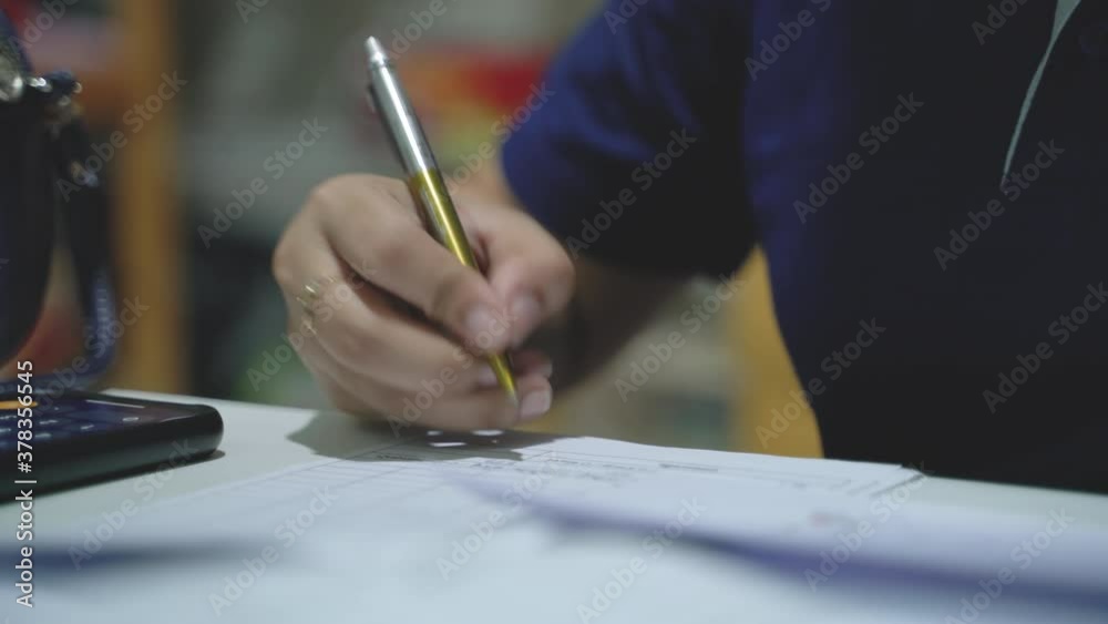 Poster Pensive woman planning working schedule writing in notebook while sitting at working place, female administrative manager making notes of information browsed on netbook