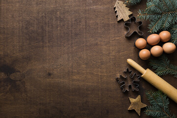 Christmas border with ingredients for baking gingerbread cookies on wooden background. View from...