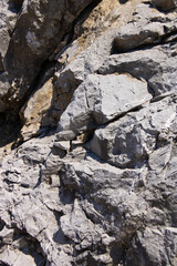 A close up of the surface of the grey stone.Close-up of a rocky cliff. Stones. Background.